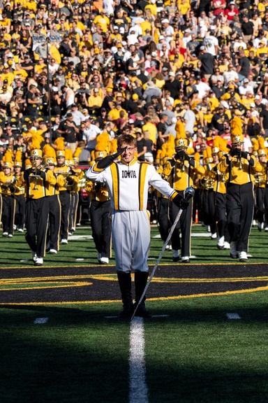 Alpers performs the Drum Major backbend, contributed by Alpers. The Drum Major backbend is a longstanding marching band tradition and is performed by the Drum Major to engage the crowd in the performance.