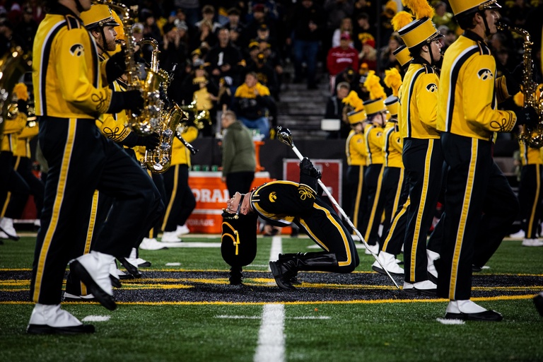 Alpers performs the Drum Major backbend, contributed by Alpers. The Drum Major backbend is a longstanding marching band tradition and is performed by the Drum Major to engage the crowd in the performance.