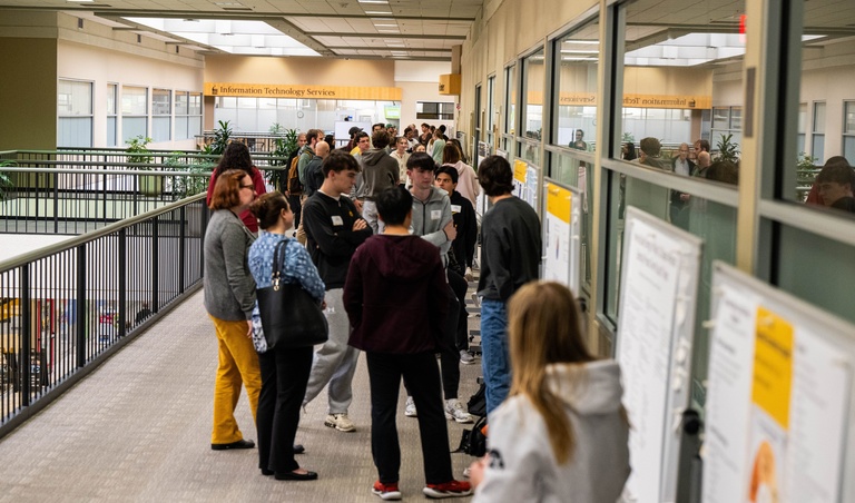 Students, staff, and faculty mingle at First-Year Seminar Poster Session. Photo by Justin Torner.